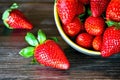Strawberies in a bowl on the wooden table. Royalty Free Stock Photo