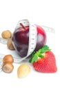 Strawberries,apple,nuts and measure tape Royalty Free Stock Photo