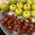 strawberries, apples and pears lie on a white plate Royalty Free Stock Photo