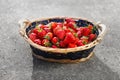 Strawberries basket on gray concrete background