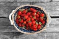 Strawberries basket on old wood background Royalty Free Stock Photo