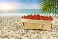 Strawberries in a basket on the shore of the warm sea