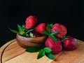 Strawberry with mint leaves in a wooden bowl. Royalty Free Stock Photo