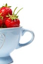 Strawberries in a blue cup on a white background Royalty Free Stock Photo