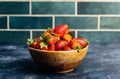 Strawberries in a bowl. Fresh strawberries in a wooden bowl on a background of the kitchen. Berries, fruits, food background Royalty Free Stock Photo