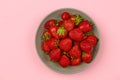 Strawberries in a bowl on a light background for insertion