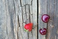 Strawberries and cherries on the surface of the old wooden table Royalty Free Stock Photo