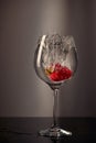 Strawberries dropped into a glass of water Royalty Free Stock Photo