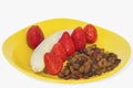 Strawberries Dry Grapes And Banana On Yellow Plate Royalty Free Stock Photo