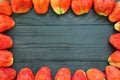 Strawberries frame on black wooden Royalty Free Stock Photo