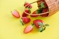 Strawberries fresh on yellow background - ripe red strawberry picking in basket