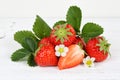 Strawberries fruits strawberry leaves on wooden board