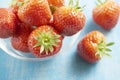 Strawberries in a glass bowl on a blue table Royalty Free Stock Photo