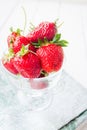 Th strawberries in the glass on the towel