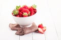 Strawberries inside bowl on white table