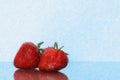 Strawberries isolated. Strawberry with leaf isolate. Two whole strawberries on white and blue. Side view Royalty Free Stock Photo