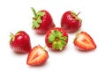 Strawberries isolated on white background, red berries whole and sliced in details, concept of fresh fruits and healthy food Royalty Free Stock Photo