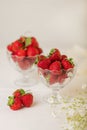 Strawberries in a jelly glass on a white background.