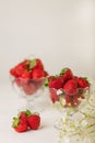 Strawberries in a jelly glass on a white background.