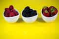 Strawberries, rasberries and blackberries in a bowl