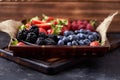 Strawberries, raspberries, blueberries, blackberries on a separate dish close-up on a solid concrete background. Healthy eating Royalty Free Stock Photo