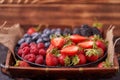 Strawberries, raspberries, blueberries, blackberries on a separate dish close-up on a solid concrete background. Healthy eating Royalty Free Stock Photo