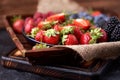 Strawberries, raspberries, blueberries, blackberries on a separate dish close-up on a solid concrete background. Healthy eating Royalty Free Stock Photo