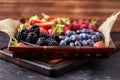 Strawberries, raspberries, blueberries, blackberries on a separate dish close-up on a solid concrete background. Royalty Free Stock Photo