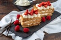 Strawberries, raspberry and Cream Mille Feuille dessert on black stone plate Royalty Free Stock Photo