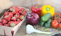 Strawberries, ripe vegetables and fruits, on the table.