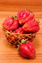 Strawberries in a small pottle on wooden table