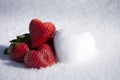 Strawberries and Snow Hearts Shape on White Snow Background