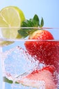 Strawberries in sparkly water with ice cubes Royalty Free Stock Photo