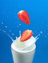 Strawberries splashing in milk Royalty Free Stock Photo