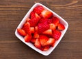 Strawberries on square bowl on wood from above Royalty Free Stock Photo