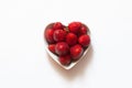 Strawberries, top view of sweet and delicious red strawberries in heart shaped bowl, isolated on white background. Royalty Free Stock Photo