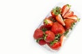 Strawberries in a transparent plastic package.Summer berry season.Isolated objects on white background. Benefit