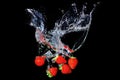 Strawberries water splashing on black Royalty Free Stock Photo