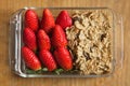 Strawberries and wheat cereals with chocolate on a wooden table. Royalty Free Stock Photo