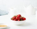 Strawberries in white bowl, on white table, morning Breakfast, summer food Royalty Free Stock Photo