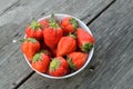 Strawberries in White bowl on wood background Royalty Free Stock Photo