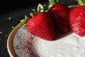 Strawberries on a white plate with a gold pattern. Ripe summer berries in drops of water Royalty Free Stock Photo