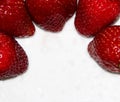 Strawberries on a white plate with a gold pattern. Ripe summer berries in drops of water Royalty Free Stock Photo