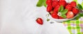 Strawberries in white porcelain bowl on a table. Bowl filled with juicy fresh ripe red strawberries. Banner with copy space Royalty Free Stock Photo