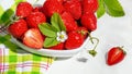 Strawberries in white porcelain bowl on a table. Bowl filled with juicy fresh ripe red strawberries Royalty Free Stock Photo