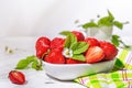 Strawberries in white porcelain bowl on a table. Bowl filled with juicy fresh ripe red strawberries. Royalty Free Stock Photo