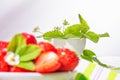 Strawberries in white porcelain bowl on a table. Bowl filled with juicy fresh ripe red strawberries Royalty Free Stock Photo