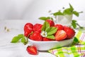 Strawberries in white porcelain bowl on a table. Bowl filled with juicy fresh ripe red strawberries Royalty Free Stock Photo