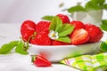 Strawberries in white porcelain bowl on a table. Bowl filled with juicy fresh ripe red strawberries Royalty Free Stock Photo