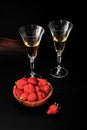 Strawberries in a wooden plate and two glasses of champagne on d Royalty Free Stock Photo